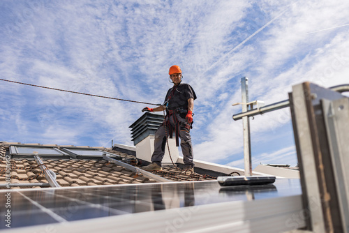 Wallpaper Mural Engineer wearing safety harness standing on rooftop Torontodigital.ca