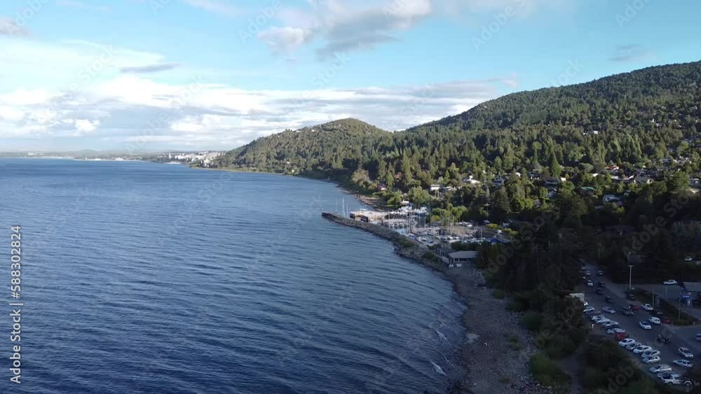 Coast next to the lake Nahuel Huapi, Bariloche, Patagonia. Road by the water. Driving cars. Coast next to the lake Nahuel Huapi, Bariloche, Patagonia. Road by the water. Driving cars.