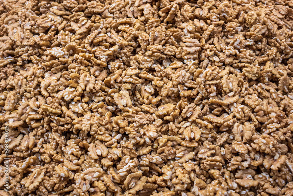 Walnut Kernels Background. Close-up Texture of Unshelled Walnut Pile, Top View. Healthy Organic food, Nutritious Diet. Walnut Kernels Background. Close-up Texture of Unshelled Walnut Pile, Top View. Healthy Organic food, Nutritious Diet.