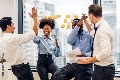 Successful of group professional business people to win of celebrating project success.Creative business giving hi five good teamwork together at office photo