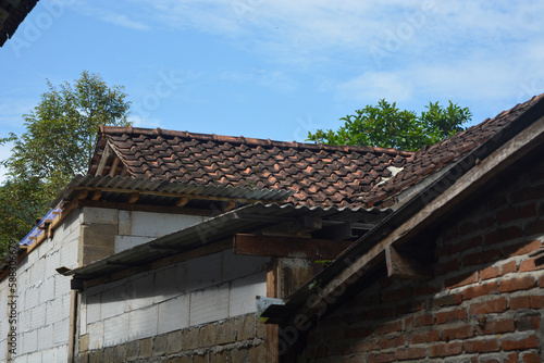 Photo of the roof of a house in the countryside made of tiles