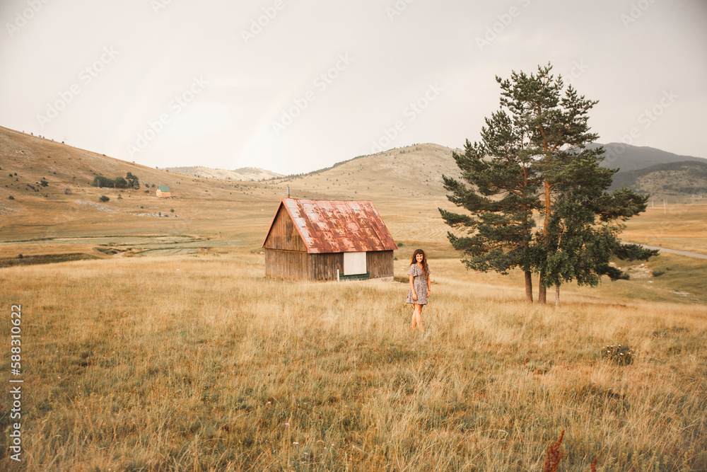 Woman standing in front of lonely building Woman standing in front of lonely building