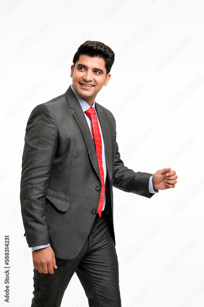 Young indian businessman giving moving or stepping expression on white background.