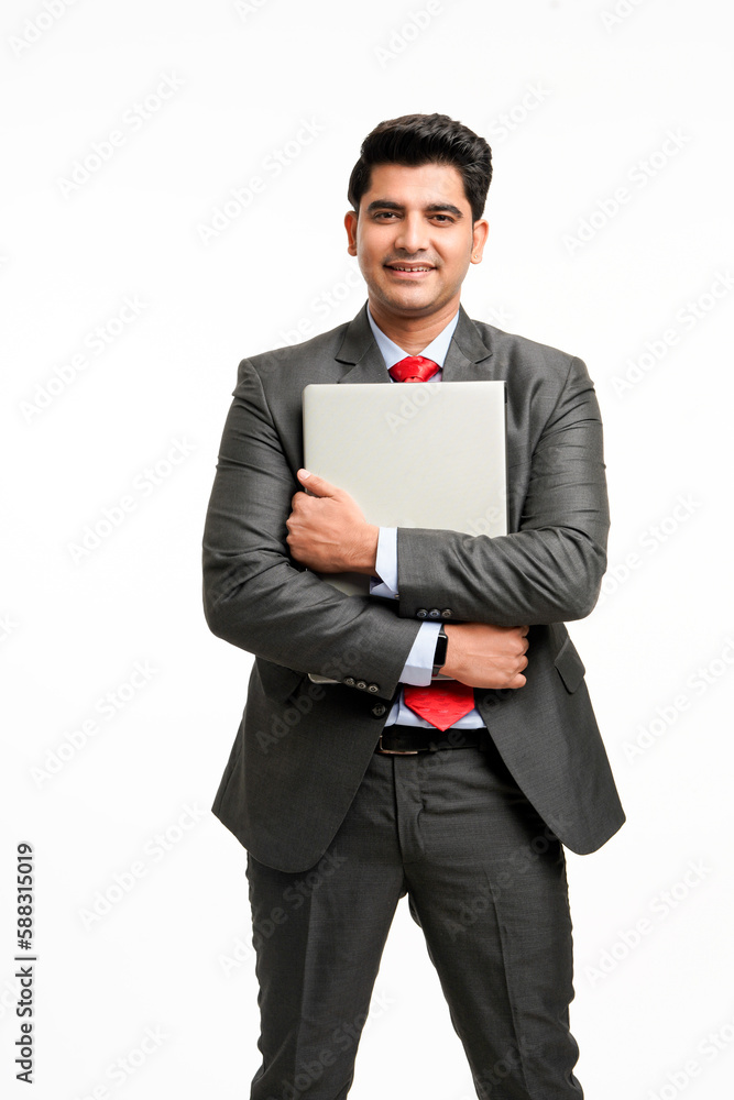 Young Indian businessman standing and holding laptop of both hand Young Indian businessman standing and holding laptop of both hand