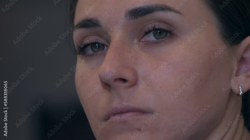 Close up of woman's face. Serious woman turn to the camera and looking. Slow motion Close up of woman's face. Serious woman turn to the camera and looking. Slow motion