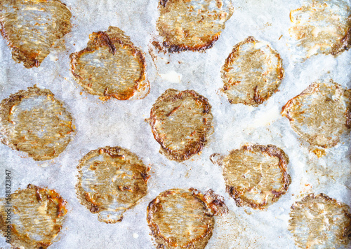 Close-up macro shot of cooking paper with greasy prints left by fried meatballs, creating appetizing and savory texture that represents frizzling cooking concept. Brown circles adds rustic and photo