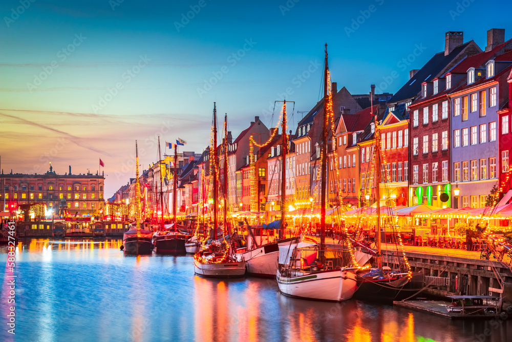 Copenhagen, Denmark. Nyhavn, Kobenhavn's iconic canal, colorful evening water reflection.