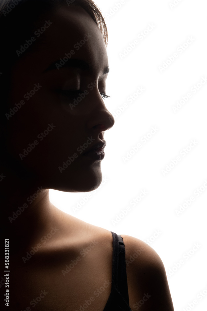 Female face. Beauty enhancement. Aesthetic cosmetology. Nose rhinoplasty. Closeup dark silhouette profile portrait of woman with closed eyes on white free space background.