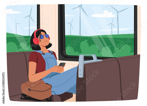 Young Woman Listening To Music With Headphones While Riding The Train. She Appears Lost In Her Own World