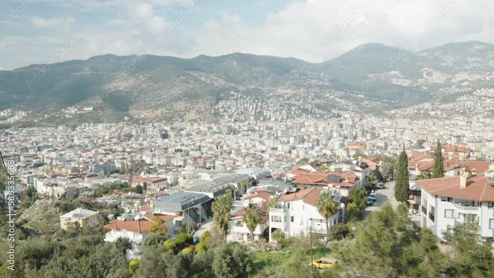 Descent from the mountain by cable car. View of the city in the mountains. Descent from the mountain by cable car. View of the city in the mountains.