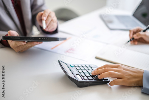 Close up hand man and woman planning budget, using calculator and laptop, reading documents, young female checking finances, counting bills or taxes, online banking services, sitting at desk