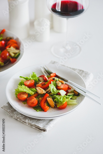 Fresh salad with mussels and tomatoes on white wooden table