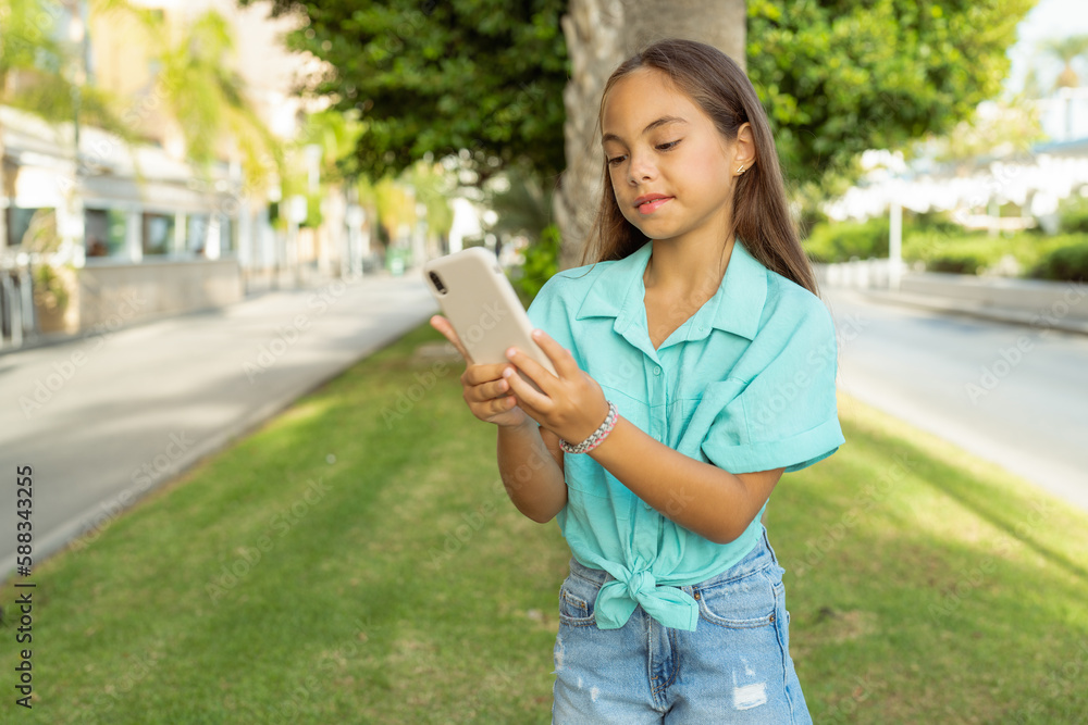 Beautiful hispanic girl smiling happy using smartphone at the city. Beautiful hispanic girl smiling happy using smartphone at the city.