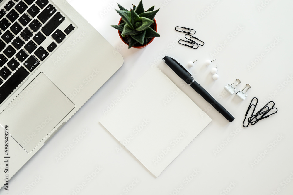 White office desk table with blank notebook, computer keyboard and other office supplies. Top view with copy space, flat lay. White office desk table with blank notebook, computer keyboard and other office supplies. Top view with copy space, flat lay.