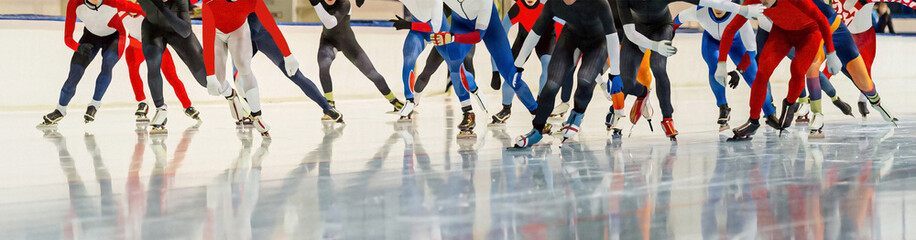 male skaters running mass start speed skating race, winter sports competition