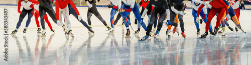 male skaters running mass start speed skating race, winter sports competition
