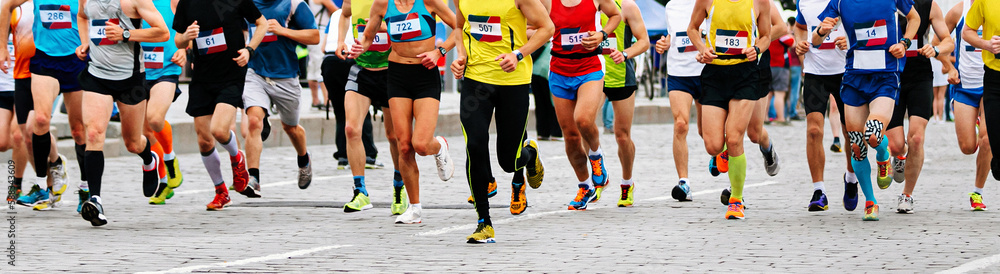 large group male and female runners run marathon, athletes jogging city race in paving stones large group male and female runners run marathon, athletes jogging city race in paving stones