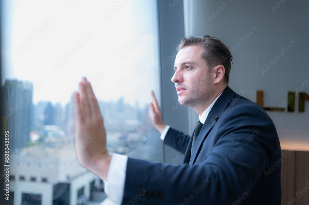 Young businessman sit and relax in the relaxation room by the window overlooking the beautiful city buildings. along with the phone to talk about business. Young businessman sit and relax in the relaxation room by the window overlooking the beautiful city buildings. along with the phone to talk about business.