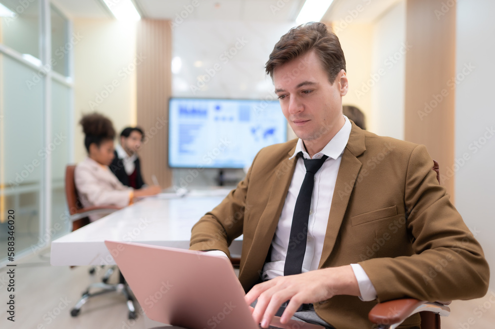 At the meeting room, a young businessman sitting in a secret meeting with many other businessmen the atmosphere is serious At the meeting room, a young businessman sitting in a secret meeting with many other businessmen the atmosphere is serious