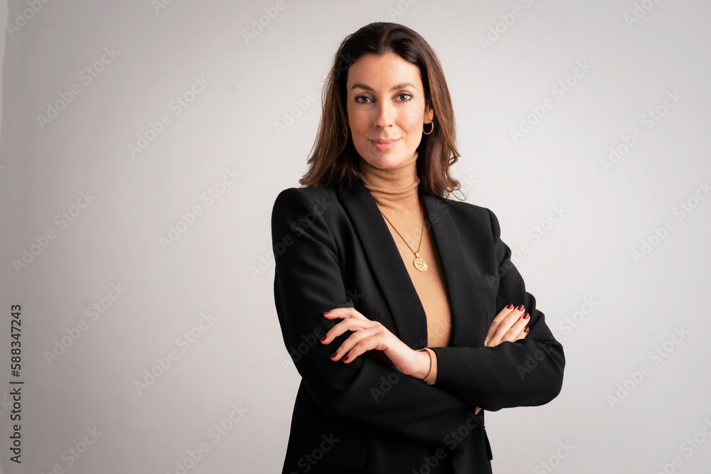 Attractive middle aged businesswoman standing with arms crossed against isolated background Attractive middle aged businesswoman standing with arms crossed against isolated background