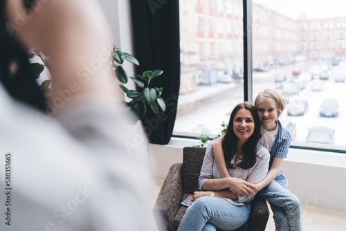 Bilde på lerret Happy woman and boy having photo session at home