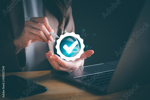 Businesswoman hand shows the sign of the top service Quality assurance, Quality assurance of business services, Guarantee, Standards, ISO certification and standardization concept. Black background.