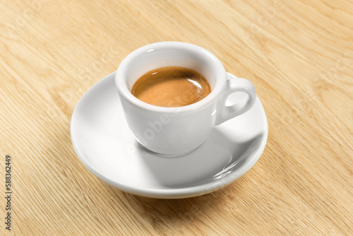 cup of coffee on wooden table – Original Creamy Arabica Coffee in Traditional White Marble Cup, with Shadow, Focus on Cream – Detailed Close-Up Macro,