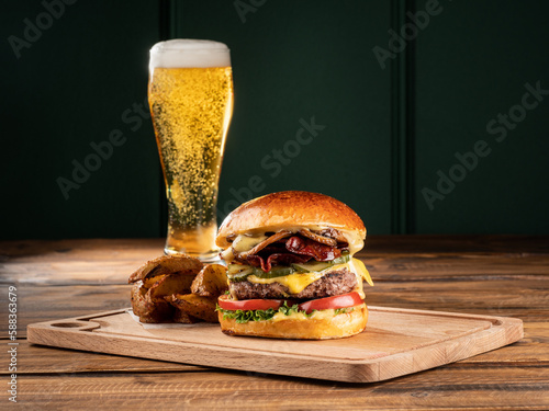 Hamburger with beer. Copy space. Vertical.