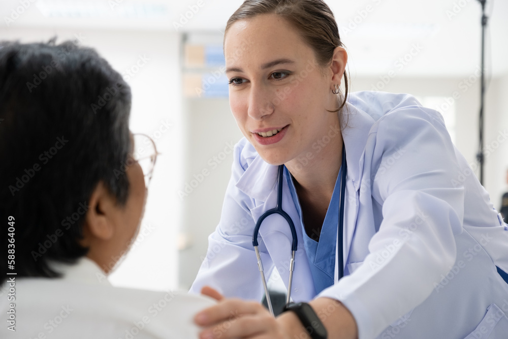 Young female doctor health examining to an old female patient and her family sitting in a wheelchair.