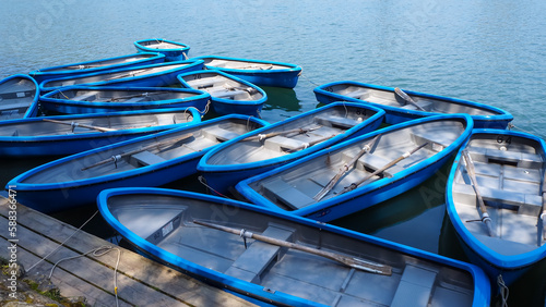 Wallpaper Mural Group of blue row boats with oars floating on the lake near the pier. High quality photo Torontodigital.ca