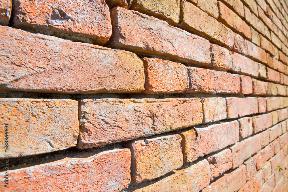 Old exposed brick wall with corrosion and deterioration of building
