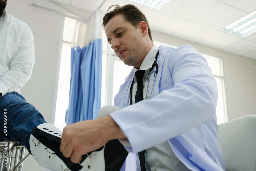 Doctors examine a black patient who has had an accident with a broken leg accompanied by his wife and child. Doctors examine a black patient who has had an accident with a broken leg accompanied by his wife and child.