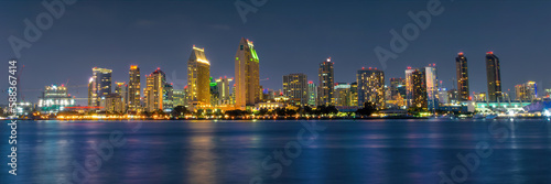 Panorama of San Diego skyline at night with water colorful reflections  view from Coronado island  California