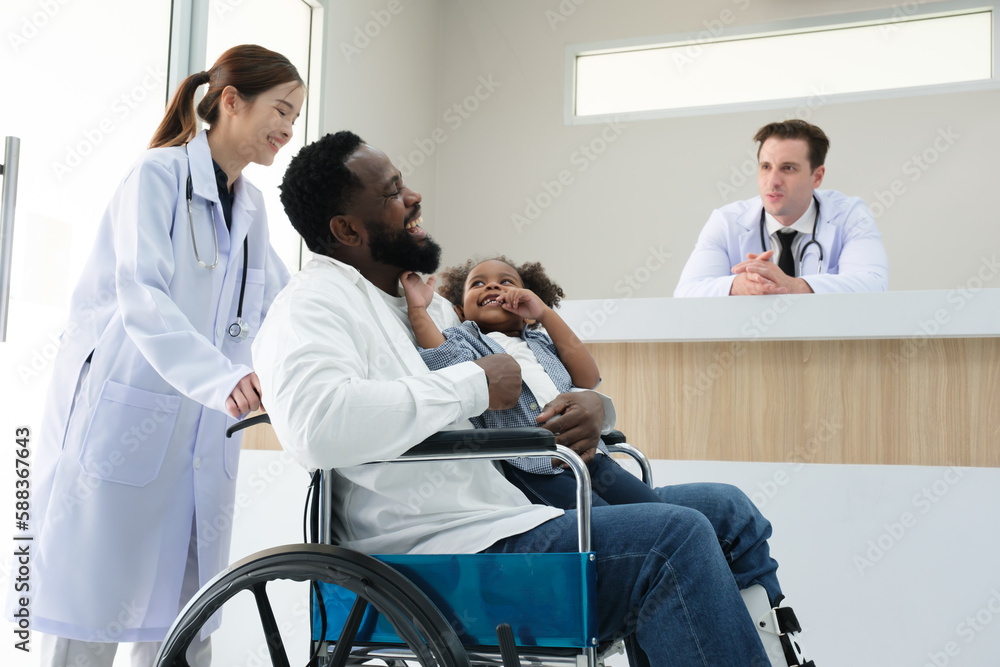 Doctors examine a black patient who has had an accident with a broken leg accompanied by his wife and child. Doctors examine a black patient who has had an accident with a broken leg accompanied by his wife and child.