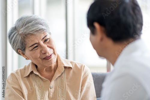 Wallpaper Mural Asian couple, elderly man and woman sitting on the sofa having fun chatting together at home. Concept: health insurance, life insurance, retirement happiness. Torontodigital.ca