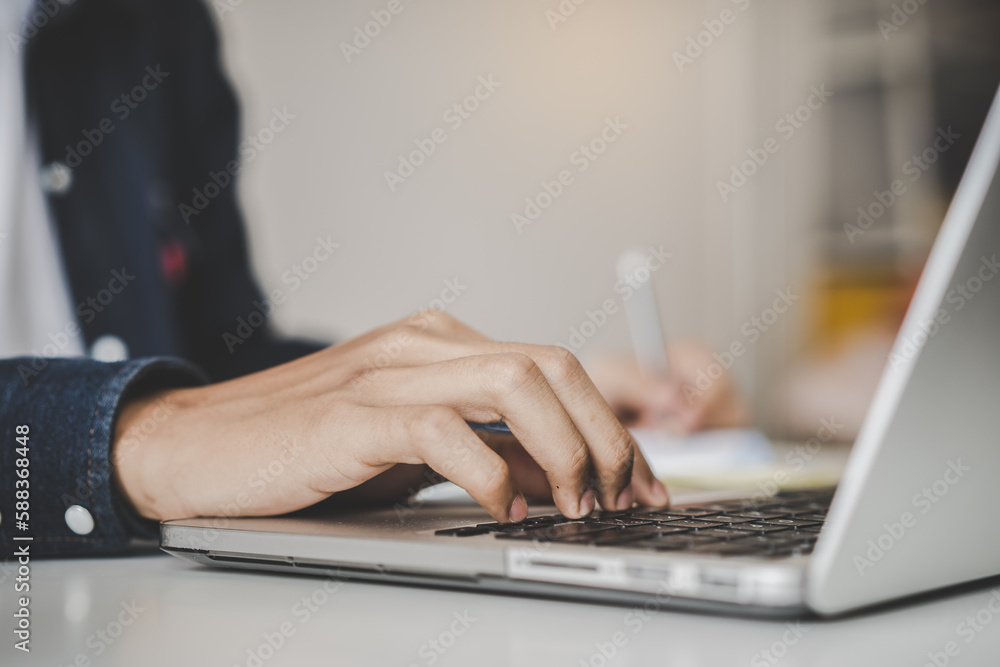 Close-up hands of people typing on laptop keyboard Close-up hands of people typing on laptop keyboard