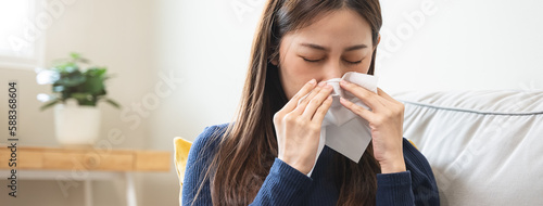 asian woman blowing nose and have allergy photo