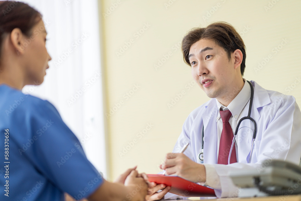 Asian doctor talking to patient with smile to encourage patients at the hospital Asian doctor talking to patient with smile to encourage patients at the hospital
