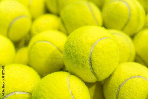 lot of bright yellow tennis balls as a background. close-up macro © diy13