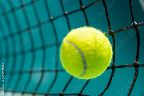 tennis ball hit a black net on the background of a tennis court © diy13