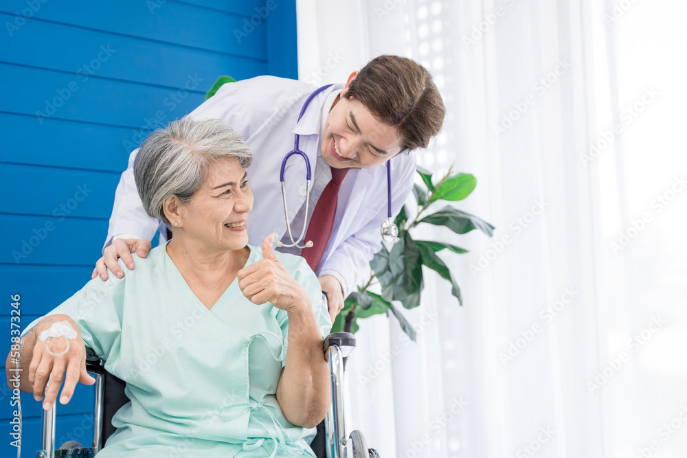 A doctor is caring for an elderly female patient at a hospital where she has undergone knee surgery. This made her need to use a wheelchair instead of walking and have a doctor take care of it closely A doctor is caring for an elderly female patient at a hospital where she has undergone knee surgery. This made her need to use a wheelchair instead of walking and have a doctor take care of it closely