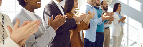 Diverse audience applauding at a public conference. Multiracial group of happy people smiling and clapping hands to express respect and gratitude to an interesting business lecturer. Header background photo