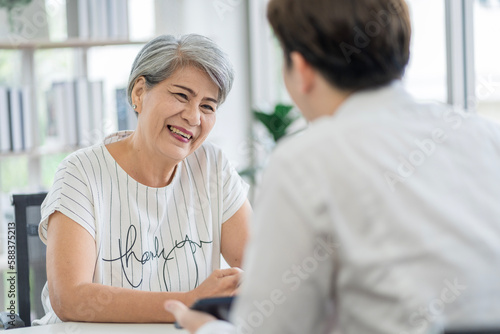 Asian seniors who are healthy  in a good mood  smiling  talking with financial or life insurance staff to take care of life after retirement.