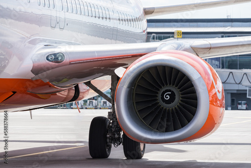 Airplane engine close-up, aircraft at airport parking lot