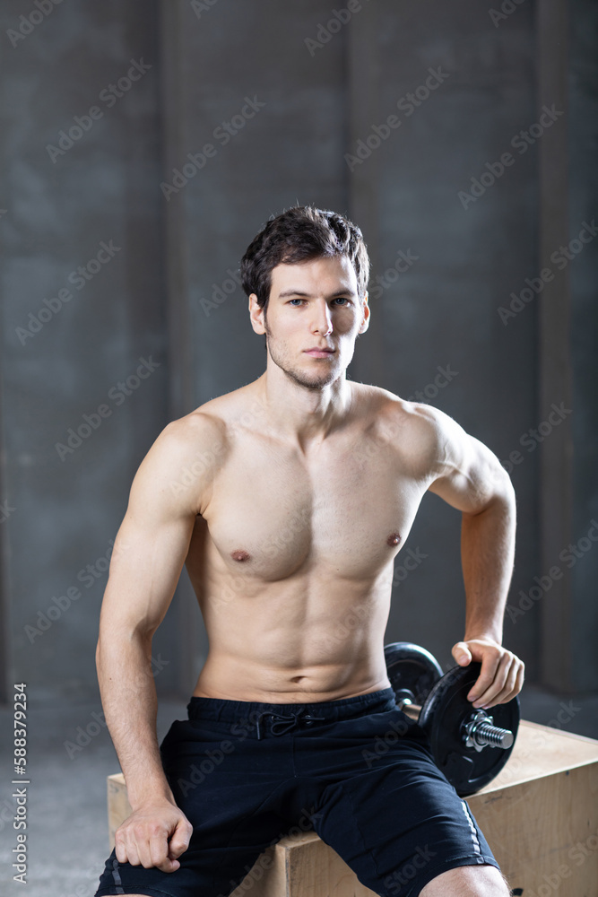 Strong  man with heavy dumbbells.