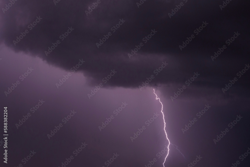 view on lightning striking from rain cloud
