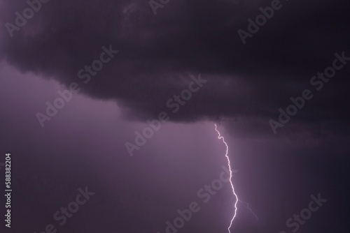 view on lightning striking from rain cloud