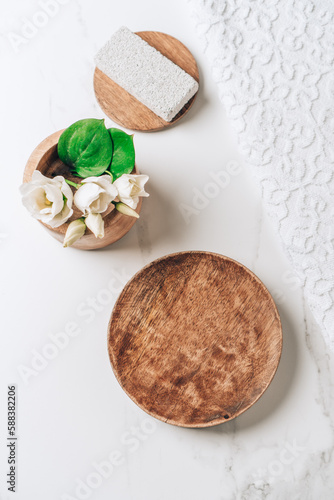 Spa cosmetics skincare product presentation scene made empty wooden plate on white bathroom table. Vertical photography.