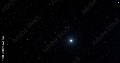 Distant alien star system with dark starry background.