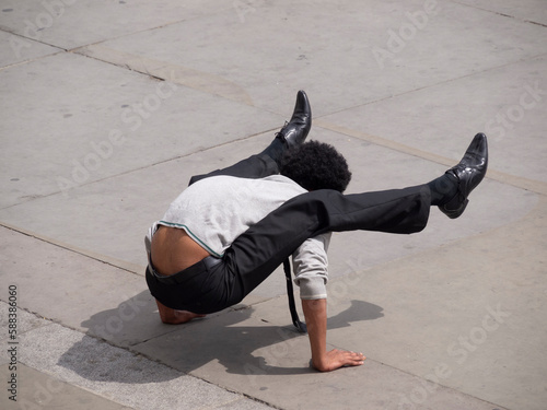 Man performing uncomfortable contortions.